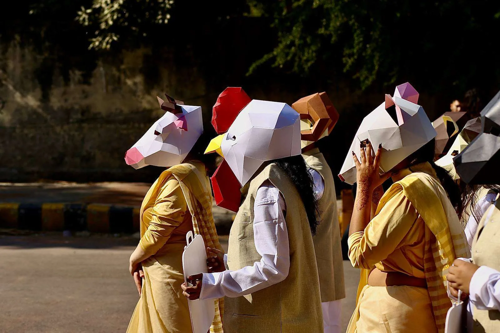 Paper chicken, cow and goat masks worn at the protest