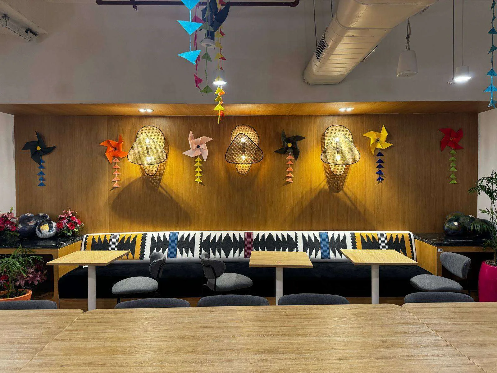 Paper pinwheels and garlands over a WeWork lounge