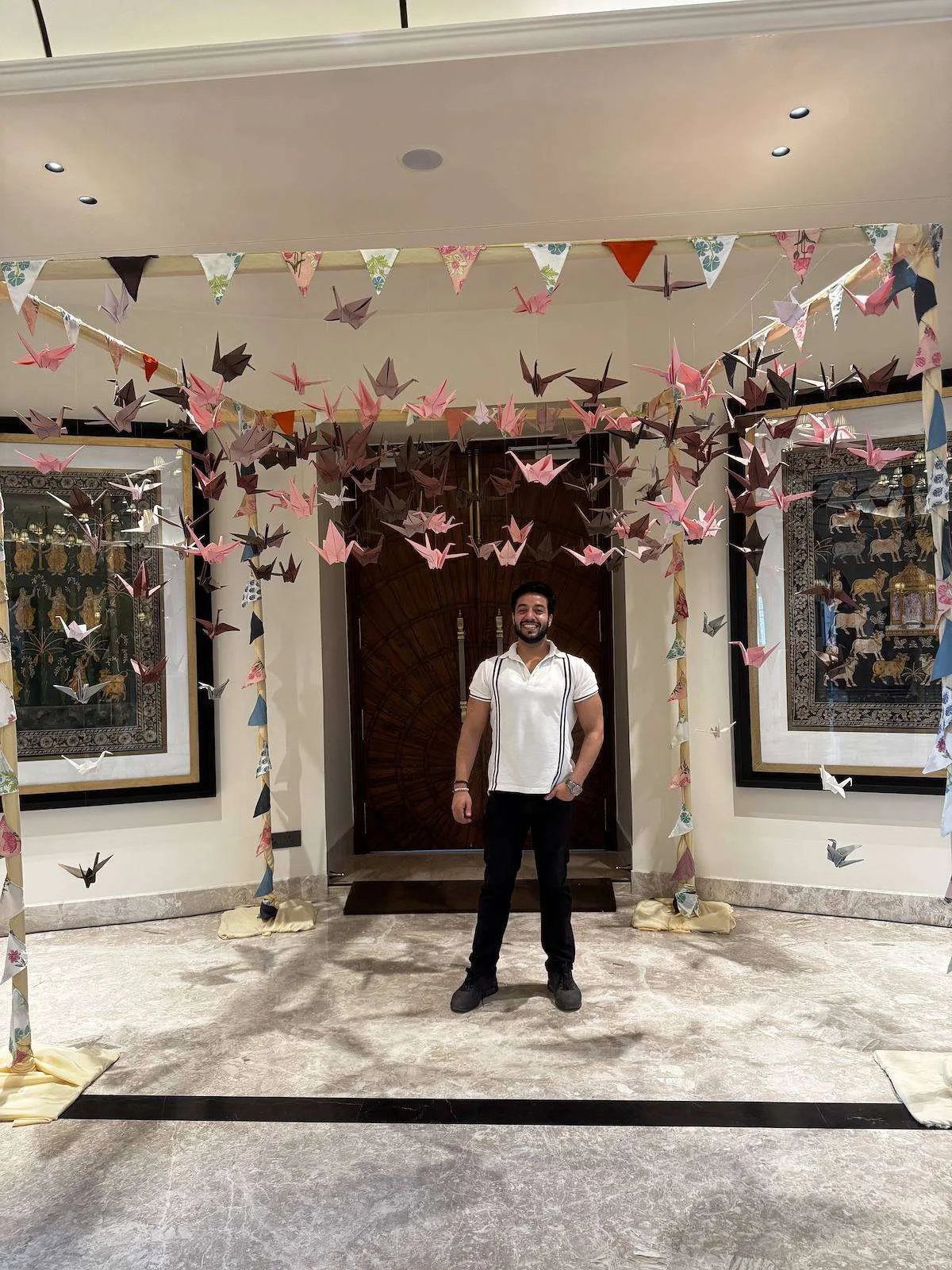 Canopy of origami birds and bunting over an entrance