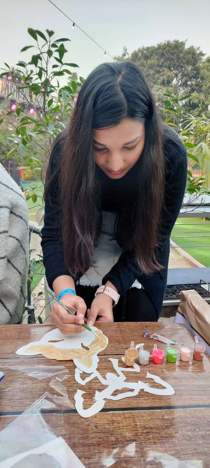Guest decorating a paper mask at the craft stall