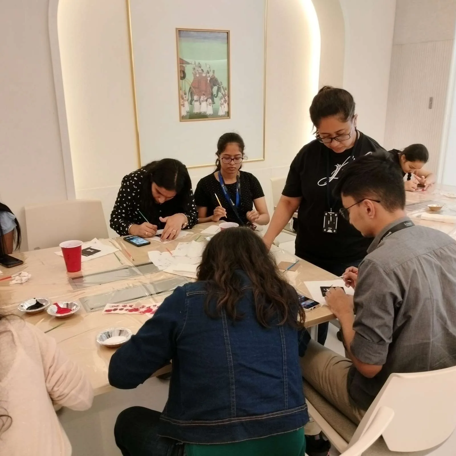 Microsoft team members painting at an art workshop