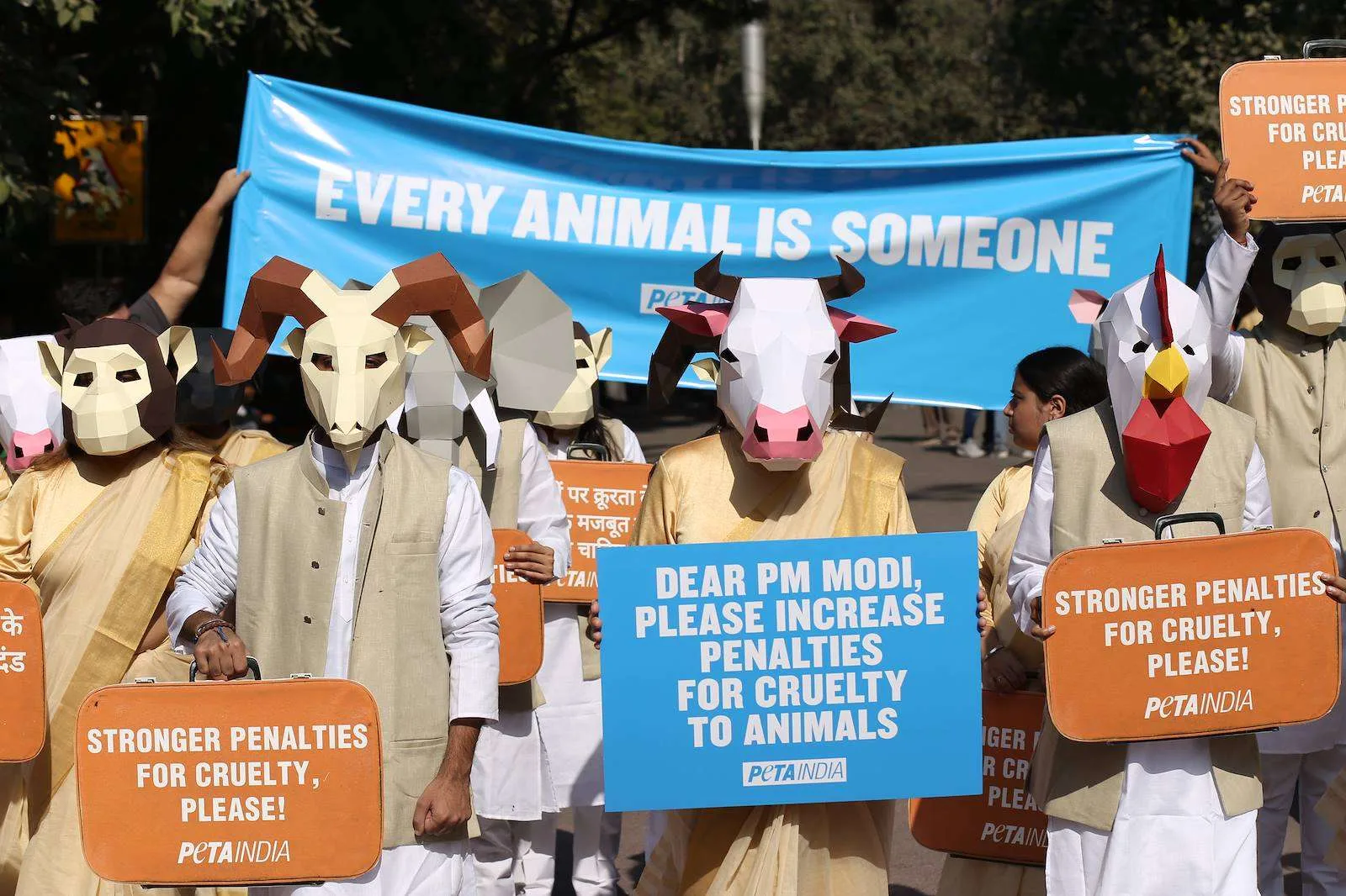 Masked campaigners holding Stronger Penalties placards