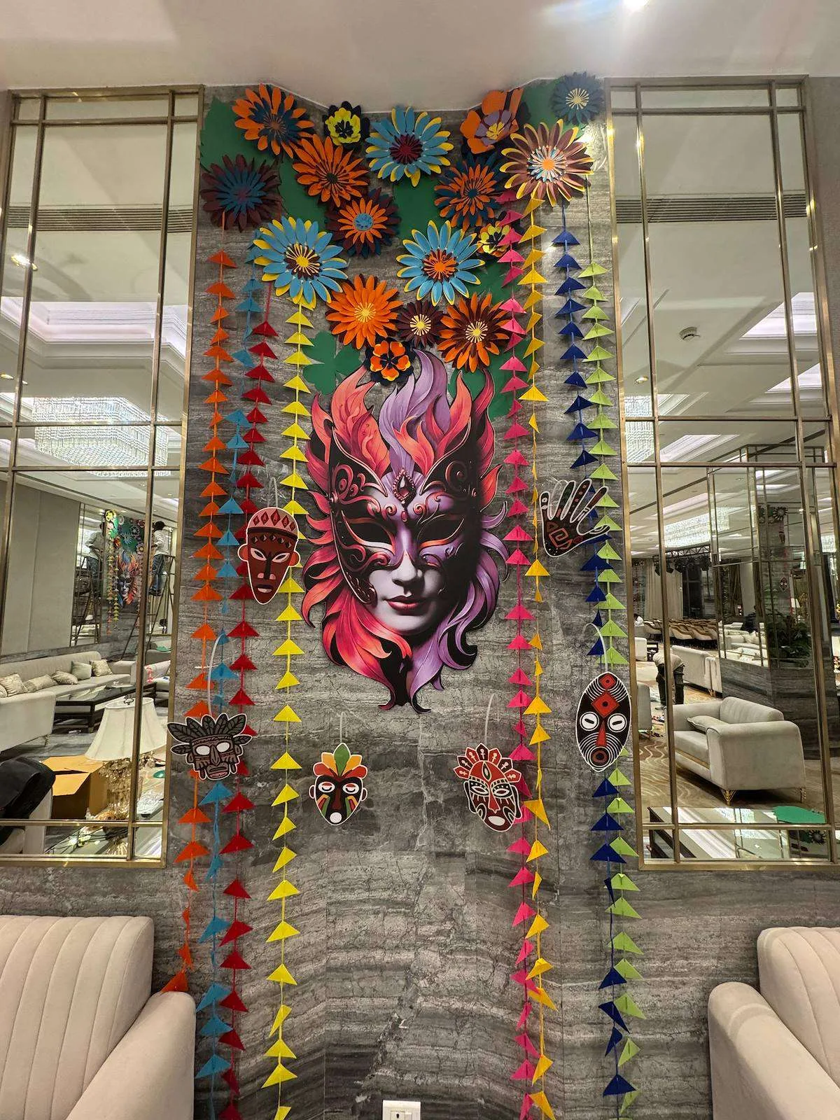 Colourful paper mask and garland column at a hotel venue
