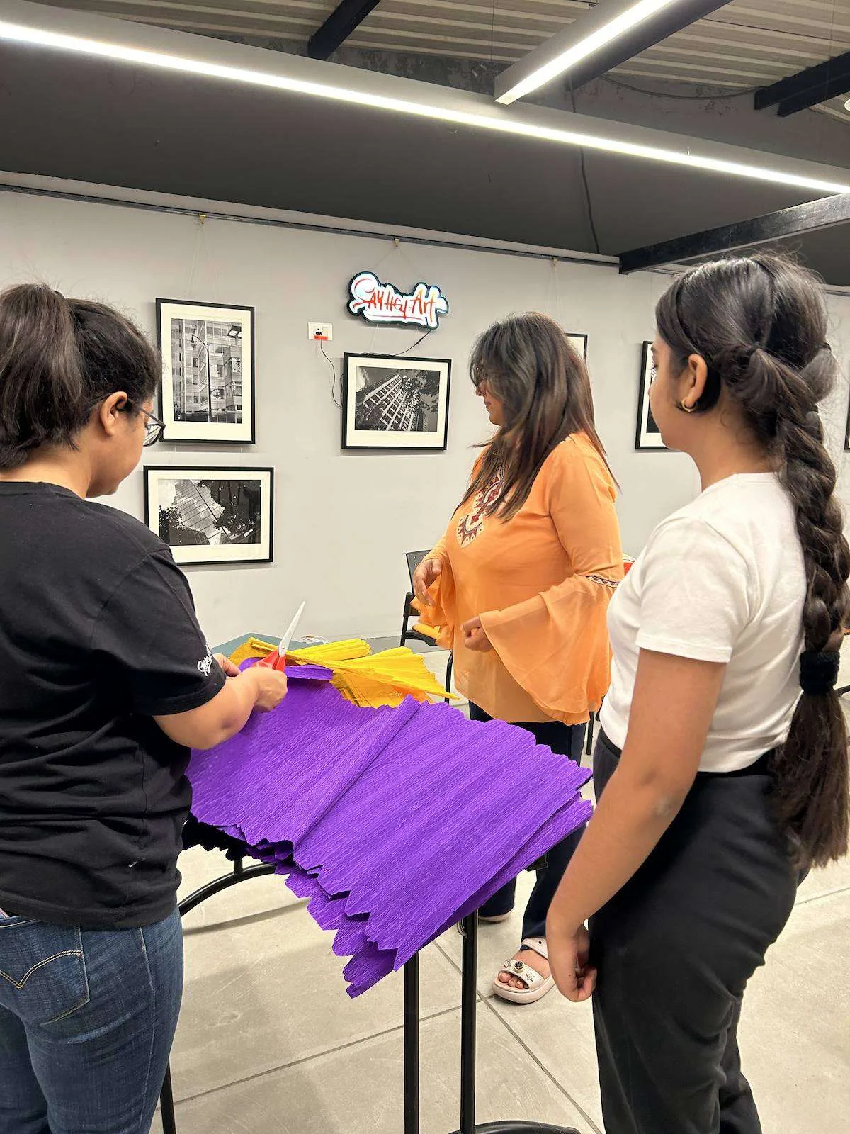 Instructor helping children with crepe paper