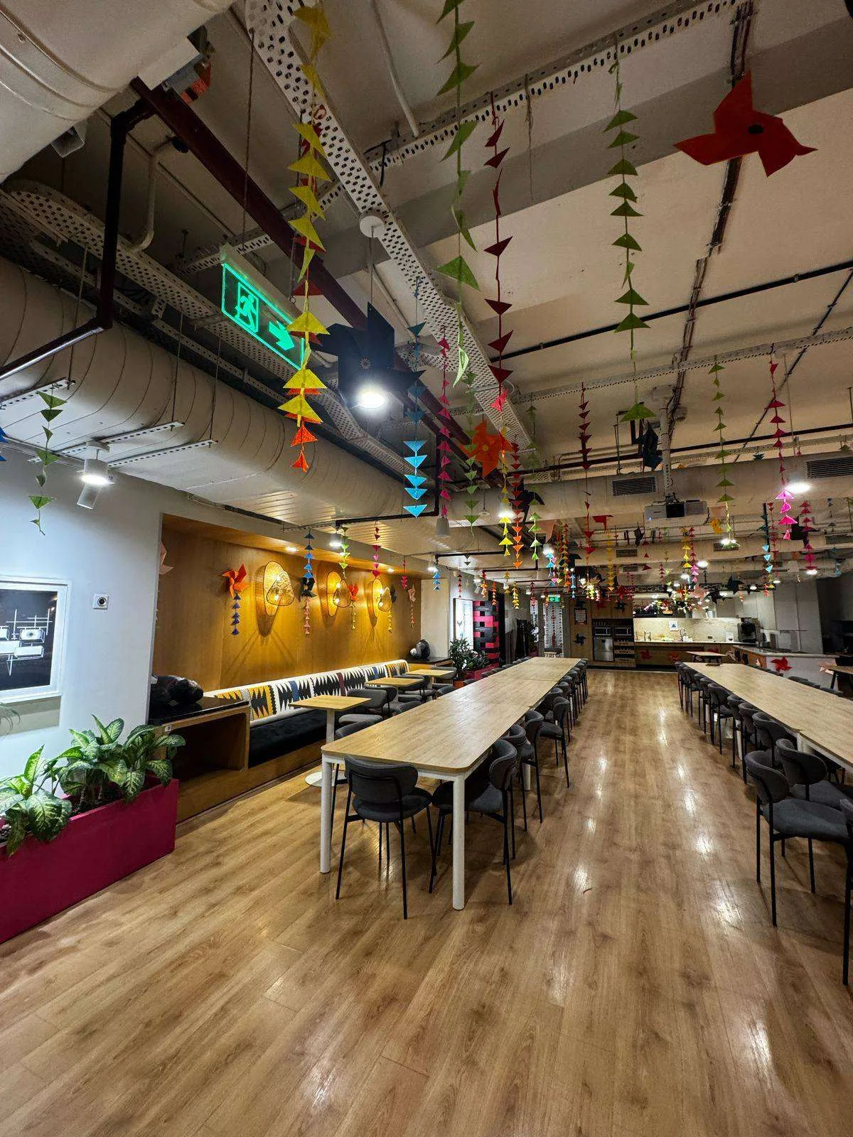 Colourful paper garlands above a long dining hall