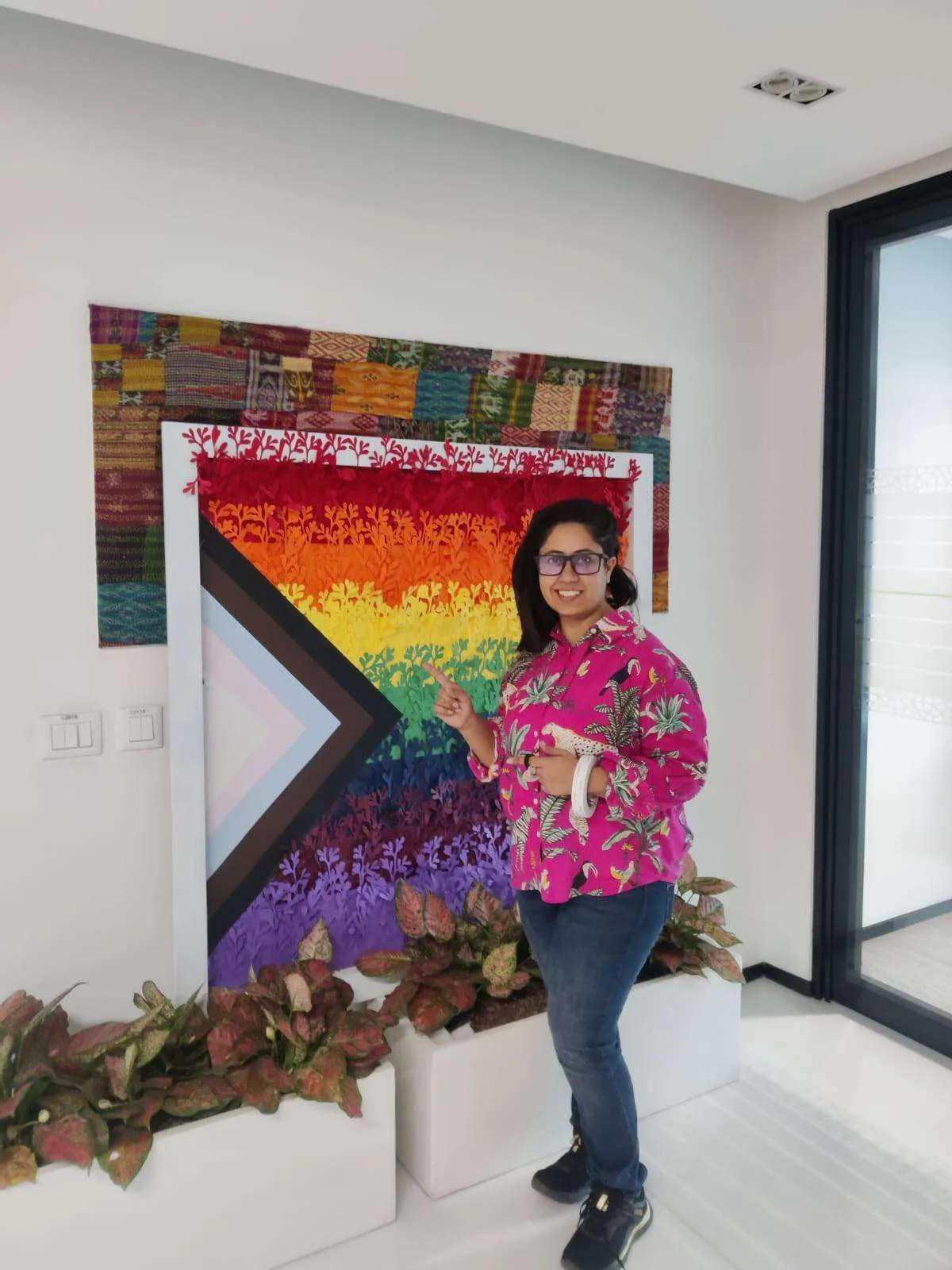 Pride flag mosaic photo wall at the BCG office