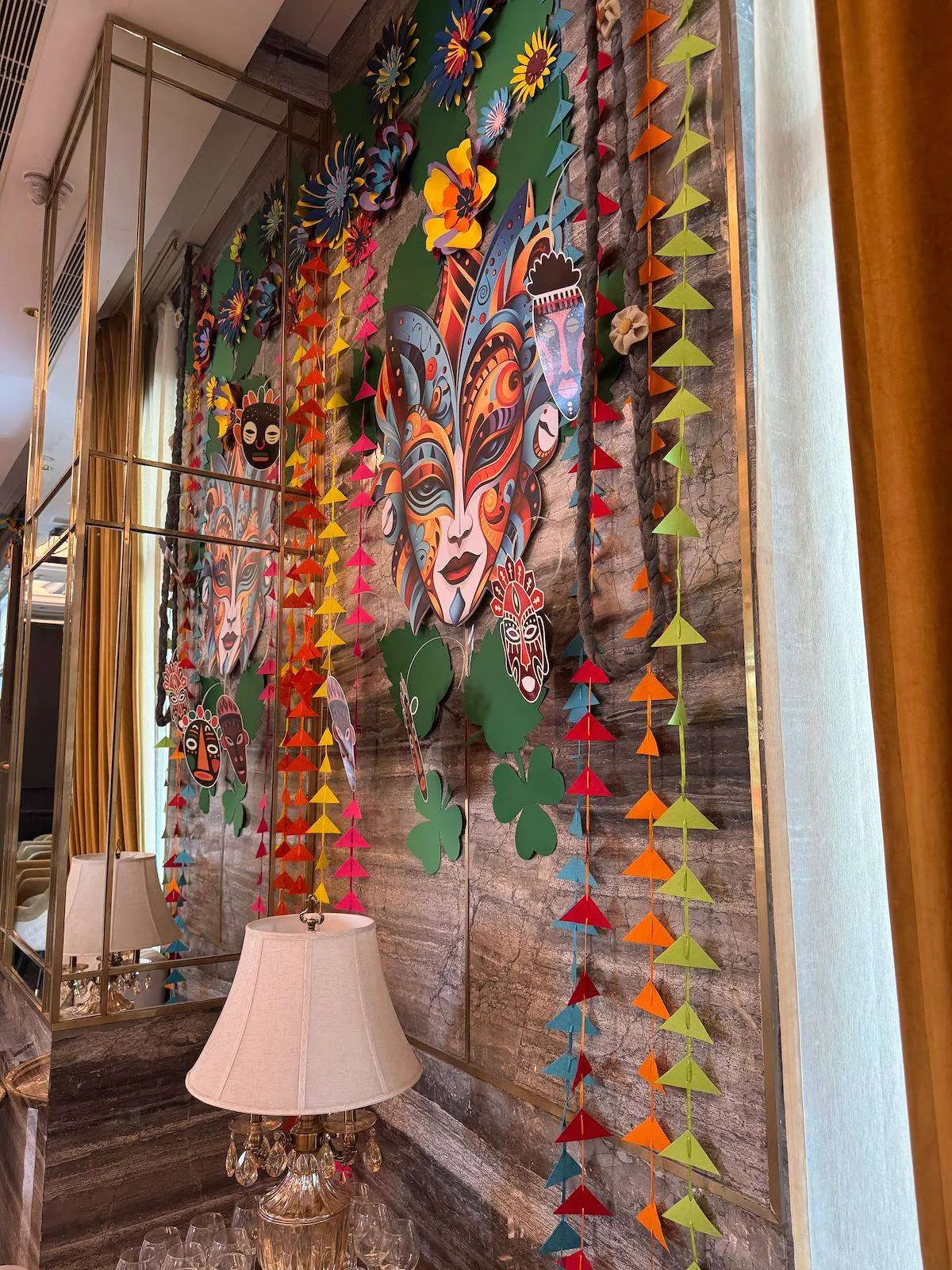 Carnival paper garland wall beside a window