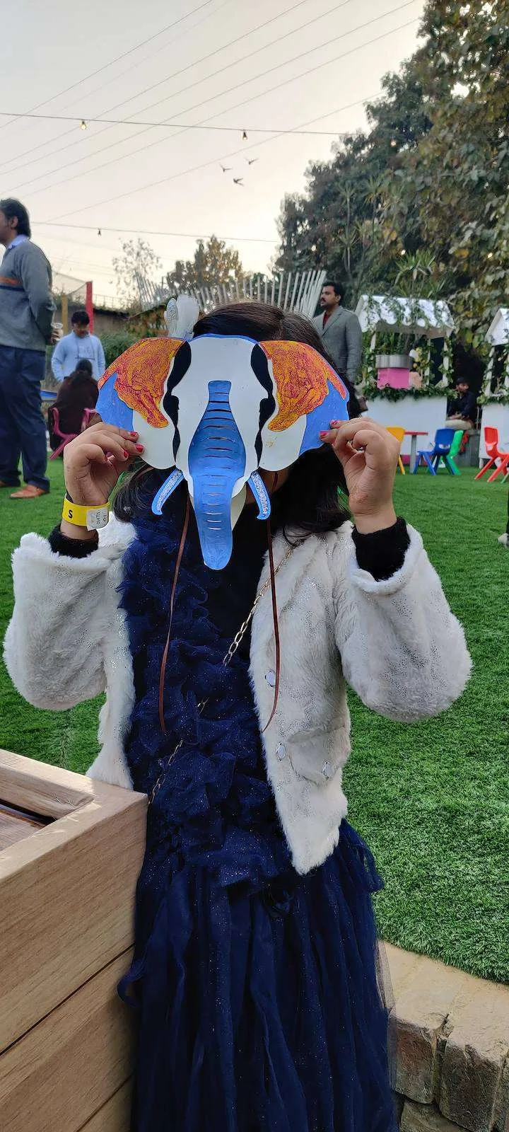 Child wearing a finished painted paper mask