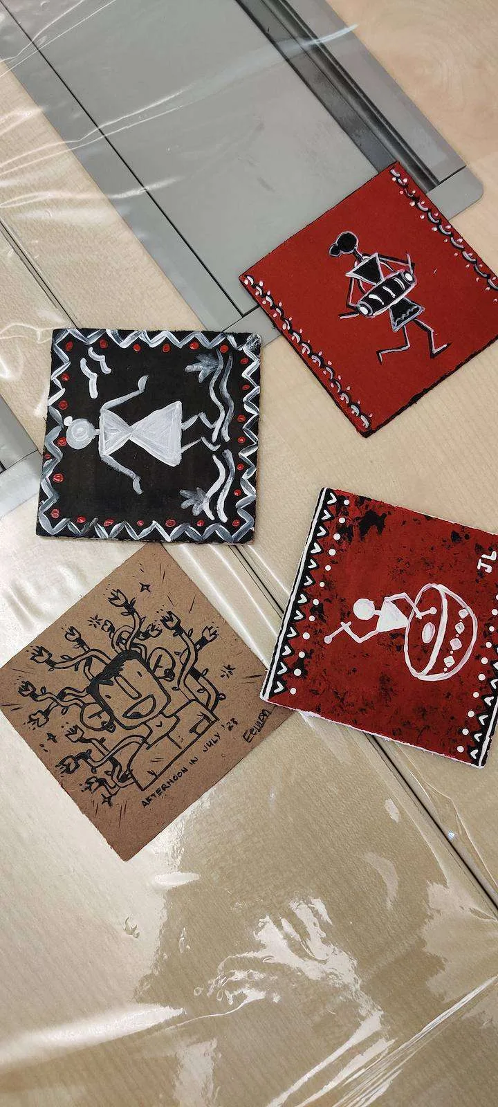 Finished Warli art coasters from the workshop