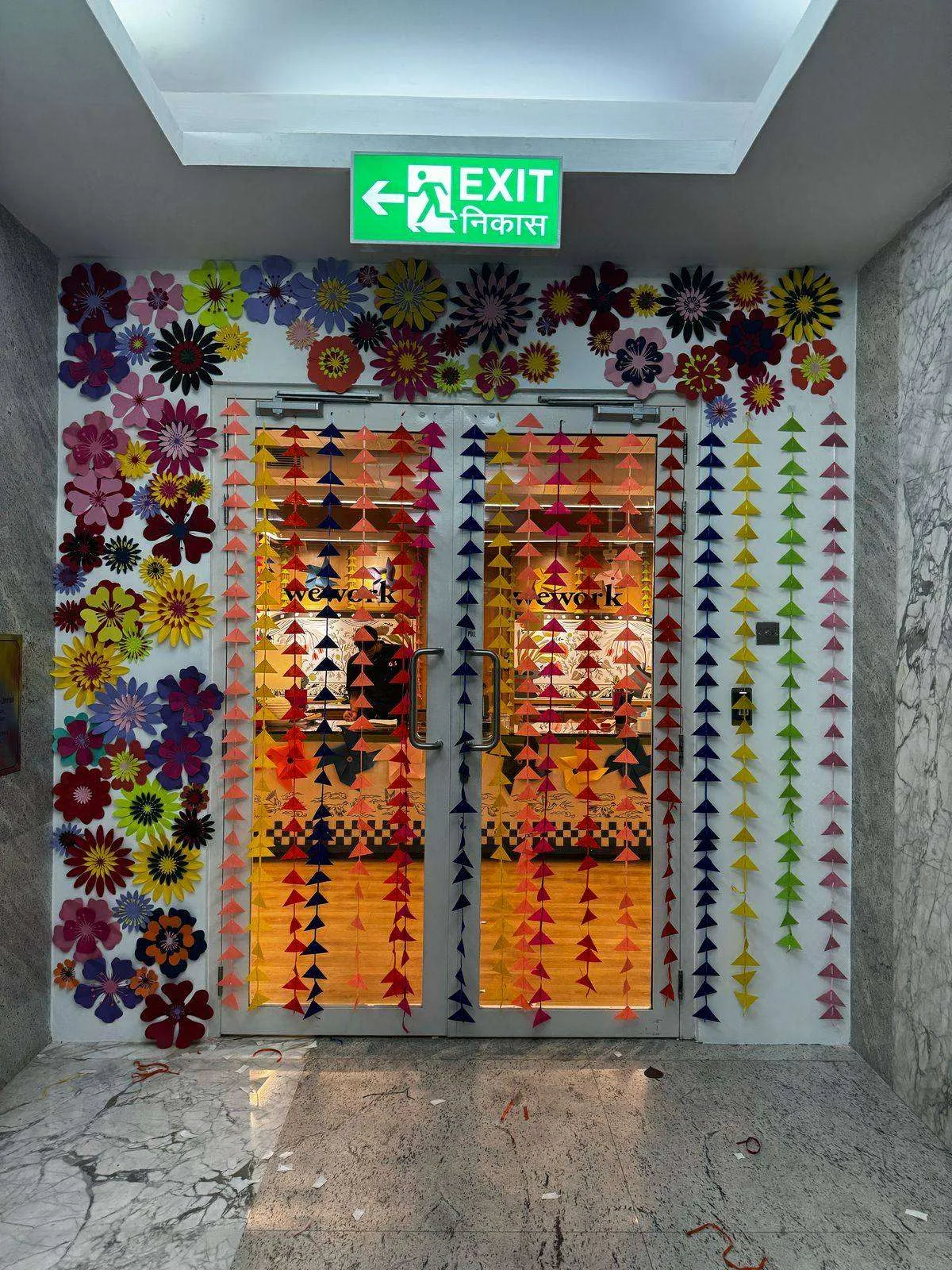 Paper flower doorway installation at WeWork