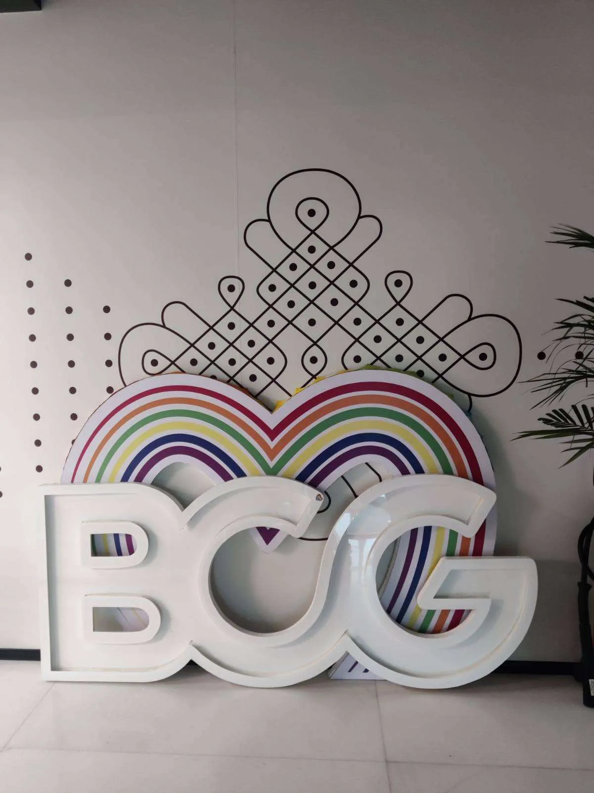 BCG logo with a paper rainbow installation for Pride Month