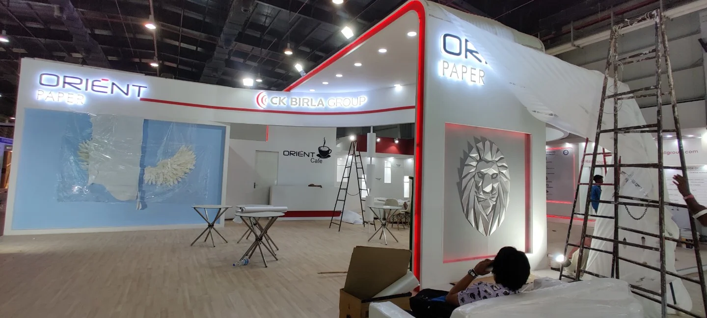 Exhibition stall with origami lion artwork during setup