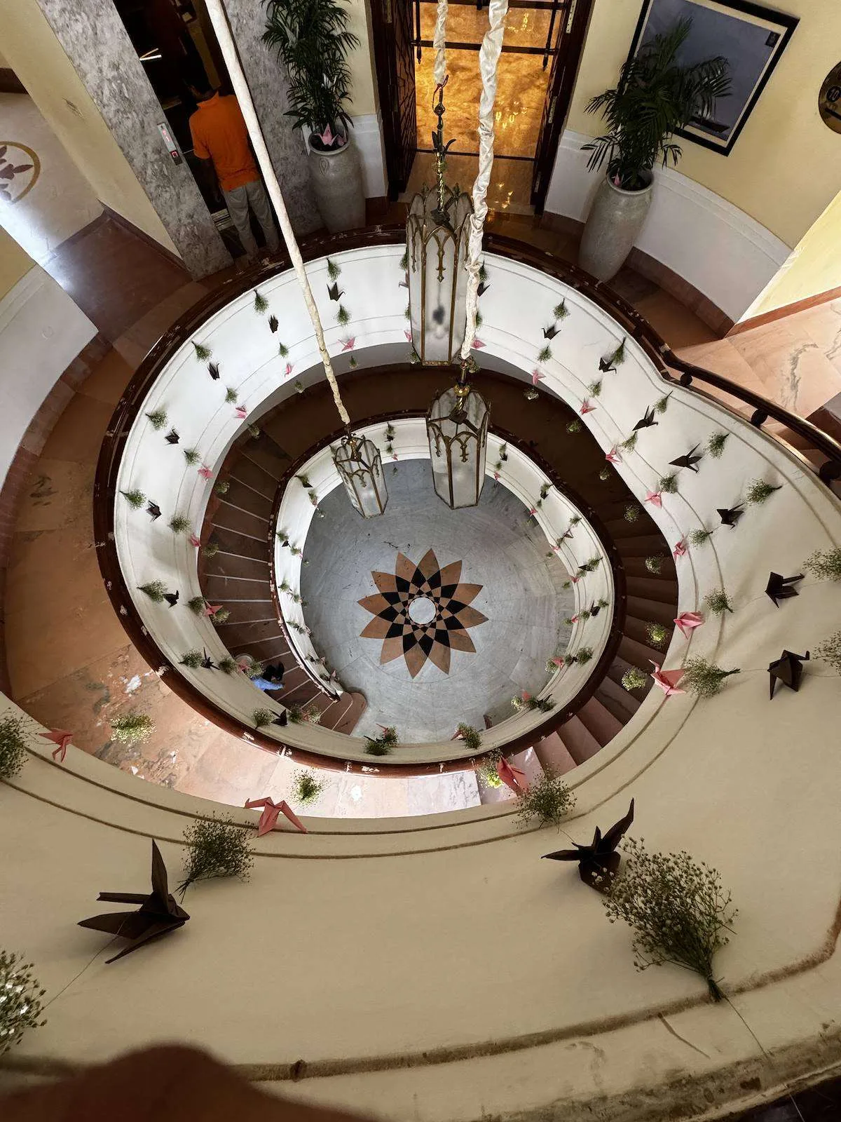 Origami birds suspended above a spiral staircase